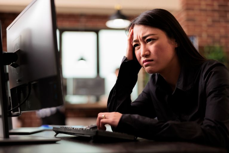 tired tech engineer was struggling keep up with demands software development project feeling stress overwork coder writing ai algorithm sitting desk it company